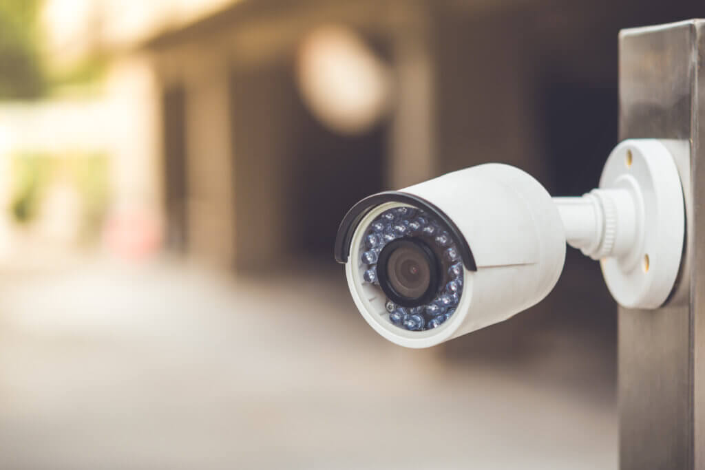 White cctv outside the building, security system with vintage color tone